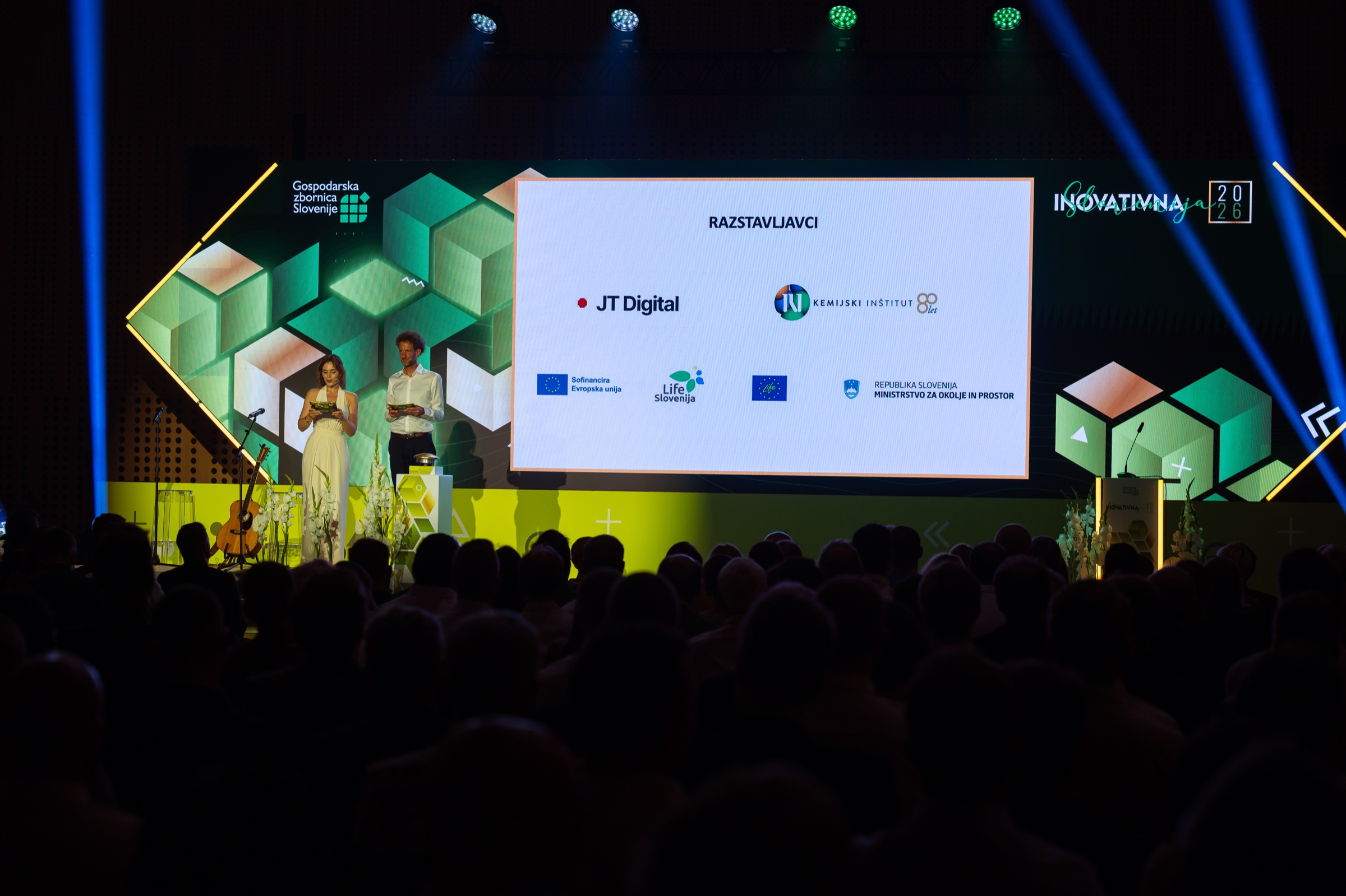 JT Digital on the exhibitors slide on the main stage of the GZS national innovation ceremony at Dan inovativnosti 2026, Brdo pri Kranju